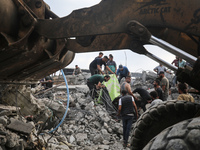 Palestinians are inspecting the site of an Israeli strike in al-Zawayda in the central Gaza Strip on August 17, 2024, amid the ongoing confl...