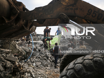 Palestinians are inspecting the site of an Israeli strike in al-Zawayda in the central Gaza Strip on August 17, 2024, amid the ongoing confl...