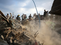 Palestinians are inspecting the site of an Israeli strike in al-Zawayda in the central Gaza Strip on August 17, 2024, amid the ongoing confl...