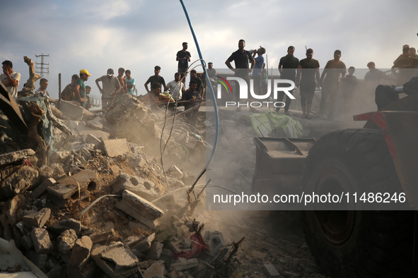 Palestinians are inspecting the site of an Israeli strike in al-Zawayda in the central Gaza Strip on August 17, 2024, amid the ongoing confl...