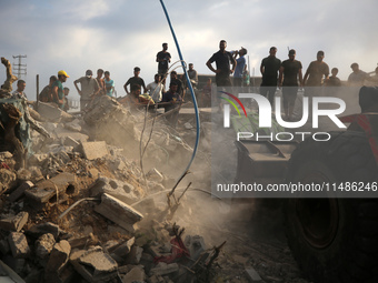 Palestinians are inspecting the site of an Israeli strike in al-Zawayda in the central Gaza Strip on August 17, 2024, amid the ongoing confl...