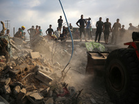 Palestinians are inspecting the site of an Israeli strike in al-Zawayda in the central Gaza Strip on August 17, 2024, amid the ongoing confl...