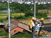 Construction workers are installing overhead contact line poles on the Fuhe River Bridge in the Beijing-Hong Kong High-speed Railway Nanchan...