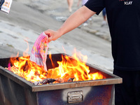 People are burning paper money to offer sacrifices to their ancestors during the Hungry Ghost Festival in Yichang, China, on August 16, 2024...