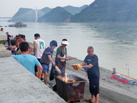 People are burning paper money to offer sacrifices to their ancestors during the Hungry Ghost Festival in Yichang, China, on August 16, 2024...