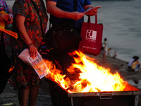 People are burning paper money to offer sacrifices to their ancestors during the Hungry Ghost Festival in Yichang, China, on August 16, 2024...