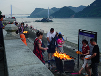 People are burning paper money to offer sacrifices to their ancestors during the Hungry Ghost Festival in Yichang, China, on August 16, 2024...