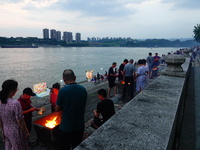 People are burning paper money to offer sacrifices to their ancestors during the Hungry Ghost Festival in Yichang, China, on August 16, 2024...