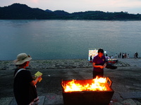 People are burning paper money to offer sacrifices to their ancestors during the Hungry Ghost Festival in Yichang, China, on August 16, 2024...