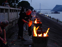 People are burning paper money to offer sacrifices to their ancestors during the Hungry Ghost Festival in Yichang, China, on August 16, 2024...