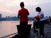 People are burning paper money to offer sacrifices to their ancestors during the Hungry Ghost Festival in Yichang, China, on August 16, 2024...