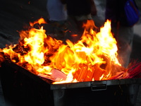 People are burning paper money to offer sacrifices to their ancestors during the Hungry Ghost Festival in Yichang, China, on August 16, 2024...