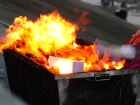 People are burning paper money to offer sacrifices to their ancestors during the Hungry Ghost Festival in Yichang, China, on August 16, 2024...