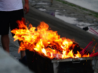 People are burning paper money to offer sacrifices to their ancestors during the Hungry Ghost Festival in Yichang, China, on August 16, 2024...