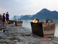 People are burning paper money to offer sacrifices to their ancestors during the Hungry Ghost Festival in Yichang, China, on August 16, 2024...