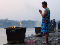 People are burning paper money to offer sacrifices to their ancestors during the Hungry Ghost Festival in Yichang, China, on August 16, 2024...