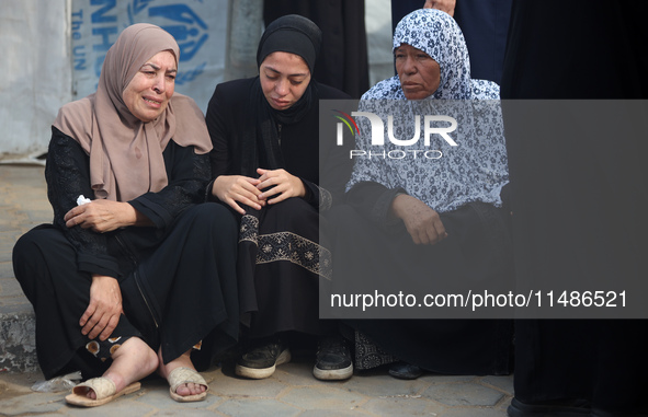 Palestinians are mourning their relatives, killed in an Israeli strike, at the Al-Aqsa Martyrs hospital in Deir el-Balah in the central Gaza...