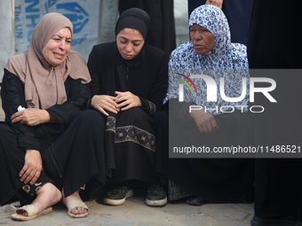 Palestinians are mourning their relatives, killed in an Israeli strike, at the Al-Aqsa Martyrs hospital in Deir el-Balah in the central Gaza...