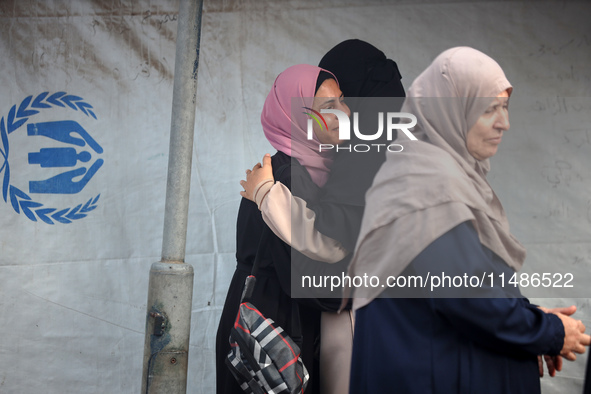 Palestinians are mourning their relatives, killed in an Israeli strike, at the Al-Aqsa Martyrs hospital in Deir el-Balah in the central Gaza...