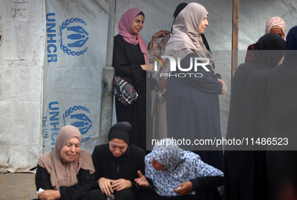 Palestinians are mourning their relatives, killed in an Israeli strike, at the Al-Aqsa Martyrs hospital in Deir el-Balah in the central Gaza...