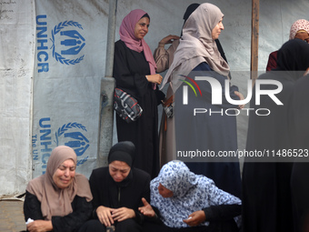 Palestinians are mourning their relatives, killed in an Israeli strike, at the Al-Aqsa Martyrs hospital in Deir el-Balah in the central Gaza...