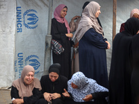 Palestinians are mourning their relatives, killed in an Israeli strike, at the Al-Aqsa Martyrs hospital in Deir el-Balah in the central Gaza...