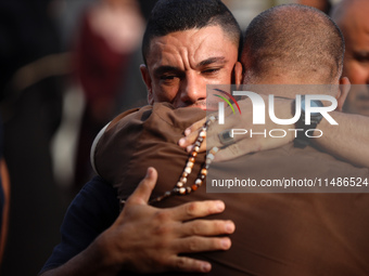 Palestinians are mourning their relatives, killed in an Israeli strike, at the Al-Aqsa Martyrs hospital in Deir el-Balah in the central Gaza...