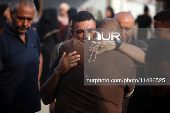 Palestinians are mourning their relatives, killed in an Israeli strike, at the Al-Aqsa Martyrs hospital in Deir el-Balah in the central Gaza...