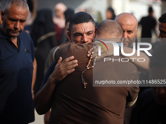 Palestinians are mourning their relatives, killed in an Israeli strike, at the Al-Aqsa Martyrs hospital in Deir el-Balah in the central Gaza...