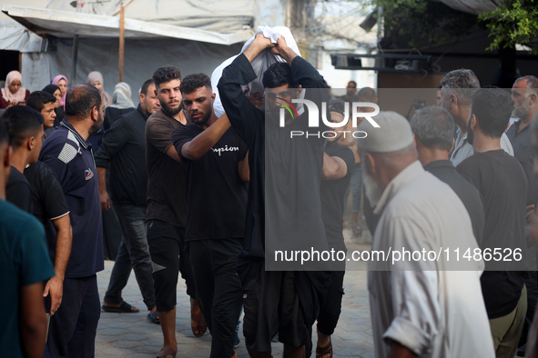 Palestinians are mourning their relatives, killed in an Israeli strike, at the Al-Aqsa Martyrs hospital in Deir el-Balah in the central Gaza...