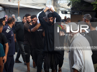 Palestinians are mourning their relatives, killed in an Israeli strike, at the Al-Aqsa Martyrs hospital in Deir el-Balah in the central Gaza...