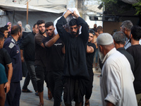 Palestinians are mourning their relatives, killed in an Israeli strike, at the Al-Aqsa Martyrs hospital in Deir el-Balah in the central Gaza...