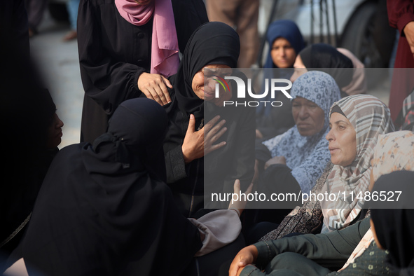 Palestinians are mourning their relatives, killed in an Israeli strike, at the Al-Aqsa Martyrs hospital in Deir el-Balah in the central Gaza...