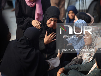 Palestinians are mourning their relatives, killed in an Israeli strike, at the Al-Aqsa Martyrs hospital in Deir el-Balah in the central Gaza...