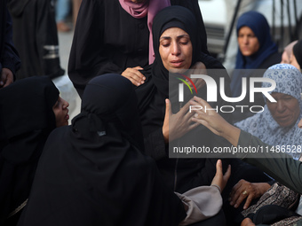 Palestinians are mourning their relatives, killed in an Israeli strike, at the Al-Aqsa Martyrs hospital in Deir el-Balah in the central Gaza...