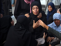 Palestinians are mourning their relatives, killed in an Israeli strike, at the Al-Aqsa Martyrs hospital in Deir el-Balah in the central Gaza...