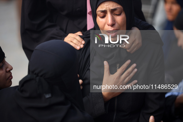 Palestinians are mourning their relatives, killed in an Israeli strike, at the Al-Aqsa Martyrs hospital in Deir el-Balah in the central Gaza...