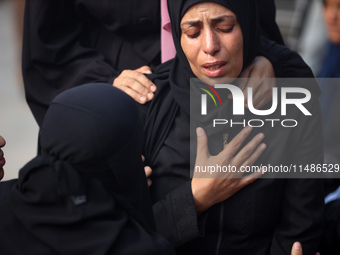 Palestinians are mourning their relatives, killed in an Israeli strike, at the Al-Aqsa Martyrs hospital in Deir el-Balah in the central Gaza...