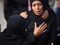 Palestinians are mourning their relatives, killed in an Israeli strike, at the Al-Aqsa Martyrs hospital in Deir el-Balah in the central Gaza...