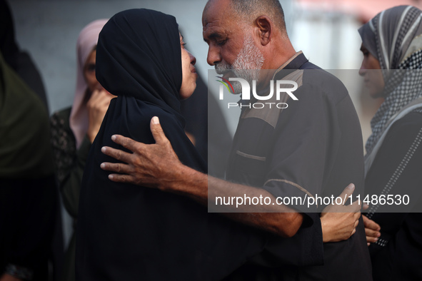 Palestinians are mourning their relatives, killed in an Israeli strike, at the Al-Aqsa Martyrs hospital in Deir el-Balah in the central Gaza...