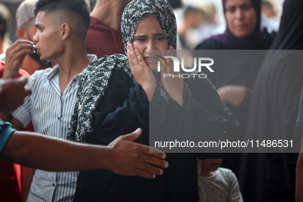 Palestinians are mourning their relatives, killed in an Israeli strike, at the Al-Aqsa Martyrs hospital in Deir el-Balah in the central Gaza...