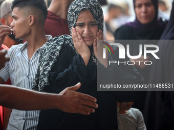 Palestinians are mourning their relatives, killed in an Israeli strike, at the Al-Aqsa Martyrs hospital in Deir el-Balah in the central Gaza...