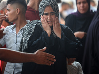 Palestinians are mourning their relatives, killed in an Israeli strike, at the Al-Aqsa Martyrs hospital in Deir el-Balah in the central Gaza...