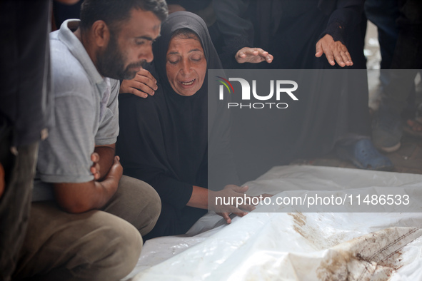 Palestinians are mourning their relatives, killed in an Israeli strike, at the Al-Aqsa Martyrs hospital in Deir el-Balah in the central Gaza...