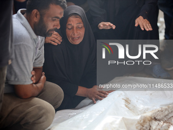 Palestinians are mourning their relatives, killed in an Israeli strike, at the Al-Aqsa Martyrs hospital in Deir el-Balah in the central Gaza...