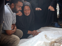 Palestinians are mourning their relatives, killed in an Israeli strike, at the Al-Aqsa Martyrs hospital in Deir el-Balah in the central Gaza...