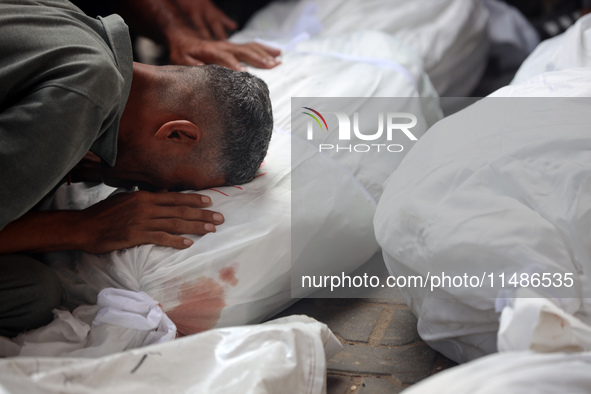 Palestinians are mourning their relatives, killed in an Israeli strike, at the Al-Aqsa Martyrs hospital in Deir el-Balah in the central Gaza...