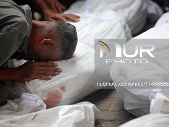 Palestinians are mourning their relatives, killed in an Israeli strike, at the Al-Aqsa Martyrs hospital in Deir el-Balah in the central Gaza...