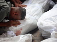 Palestinians are mourning their relatives, killed in an Israeli strike, at the Al-Aqsa Martyrs hospital in Deir el-Balah in the central Gaza...