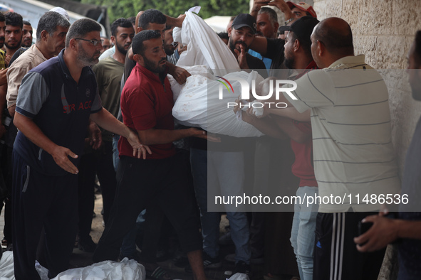 Palestinians are mourning their relatives, killed in an Israeli strike, at the Al-Aqsa Martyrs hospital in Deir el-Balah in the central Gaza...